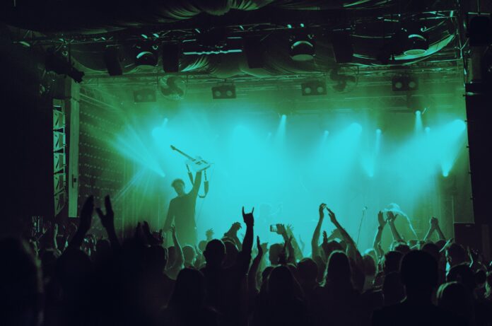 Cheering crowd having fun at music festival in a nightclub
